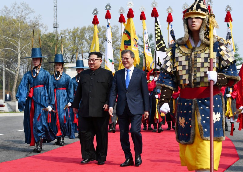 Moon and Kim with traditionally dressed Koreans