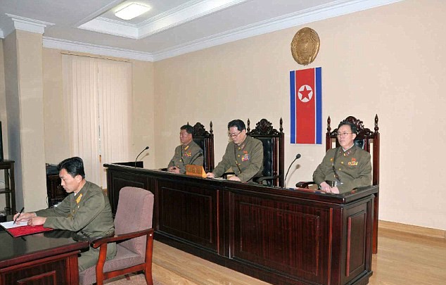 Judges seated, North Korean courtroom