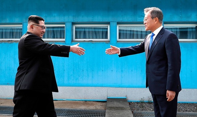 Moon and Kim shaking hands
