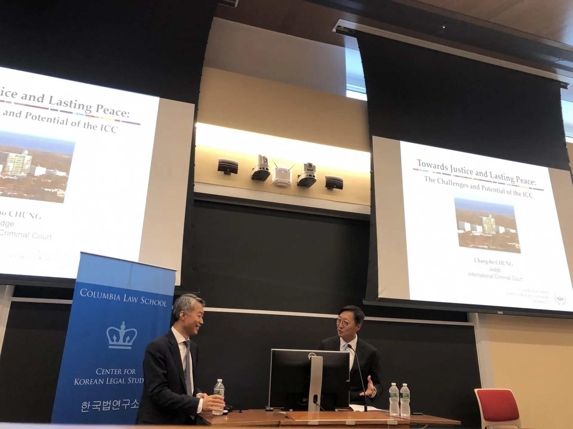 Two men speaking at podium